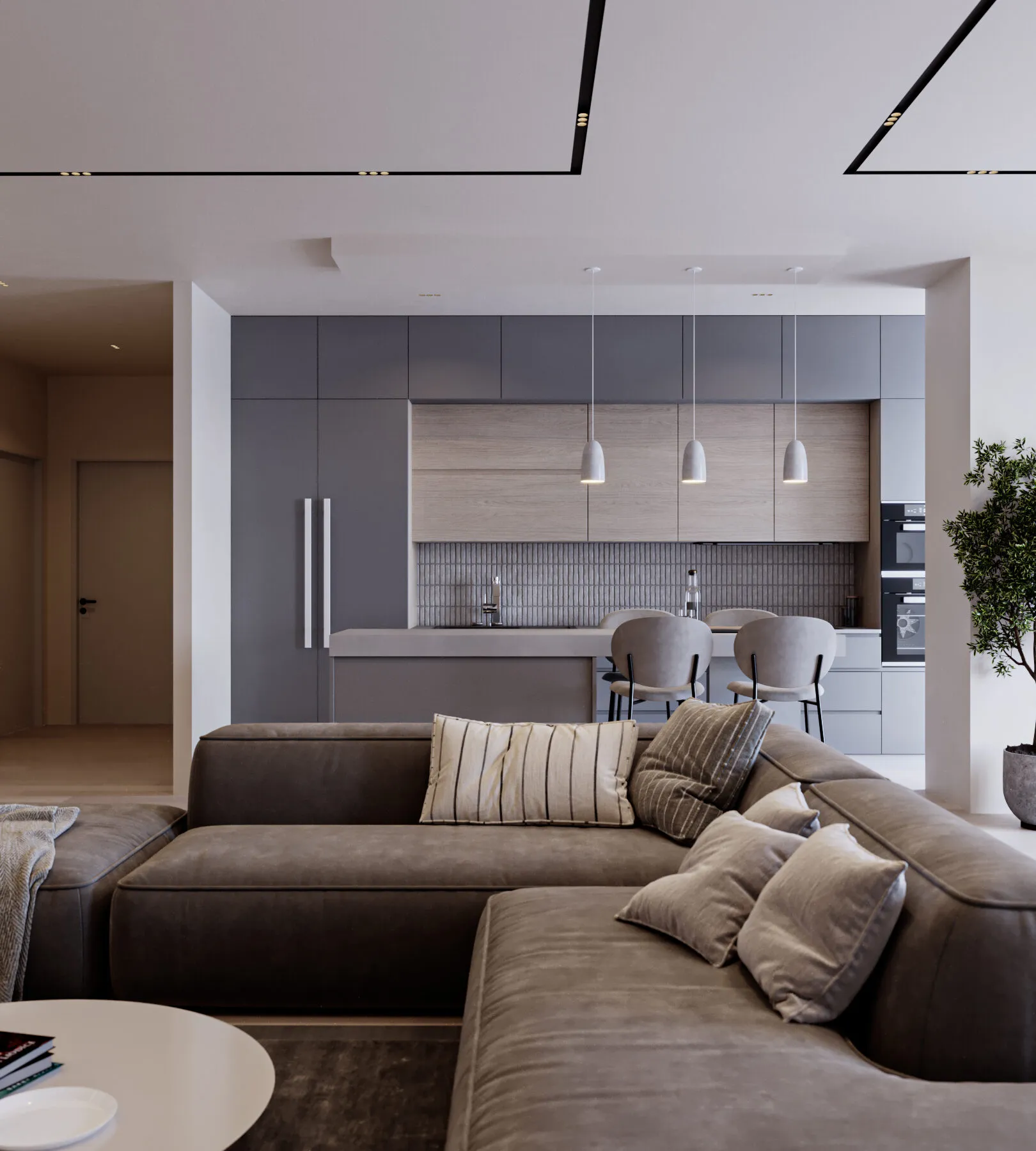Open-plan living and kitchen with a leather sectional, pendant lights and a grey kitchen island.