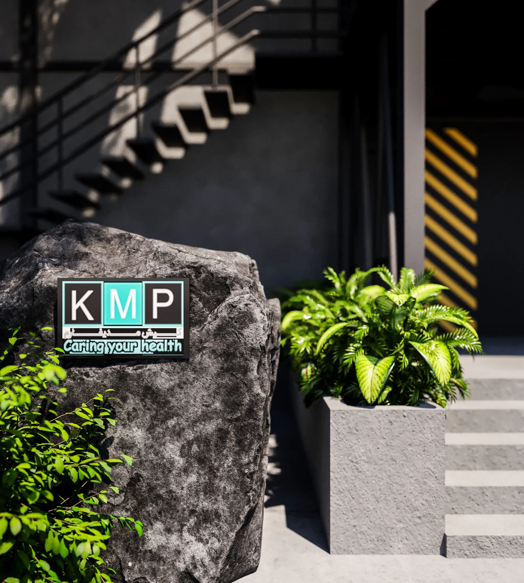 KMP company logo mounted on a large natural stone beside tropical planting.