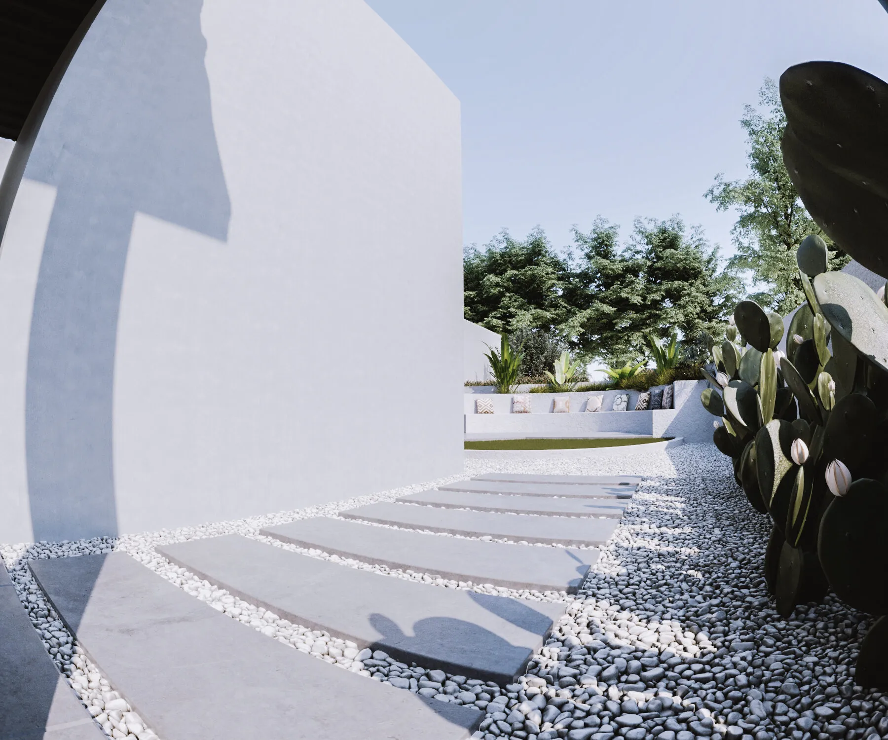 Stepping stones through white gravel beside a cactus garden.